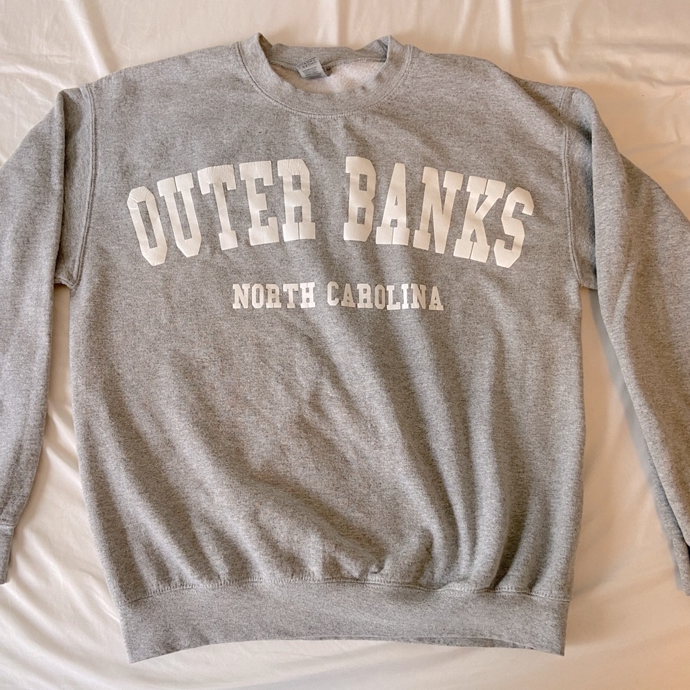 A grey Outer Banks hoodie.